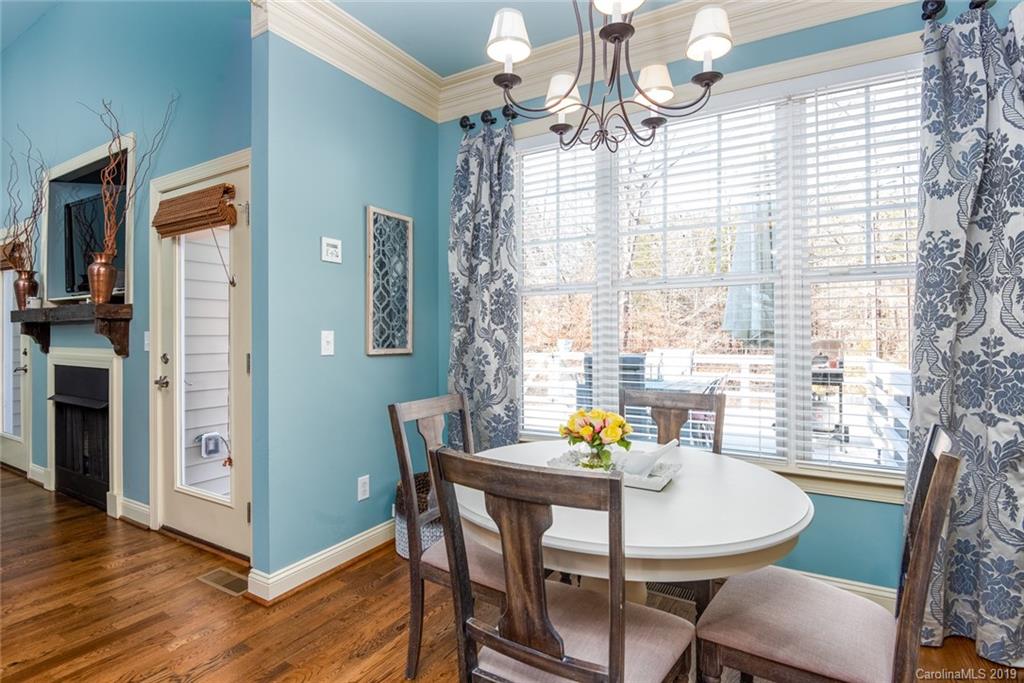 2056 Roadrunner Road Clover, SC 29710 - Photo 7 of 25 a view of a dining room with furniture a chandelier and wooden floor