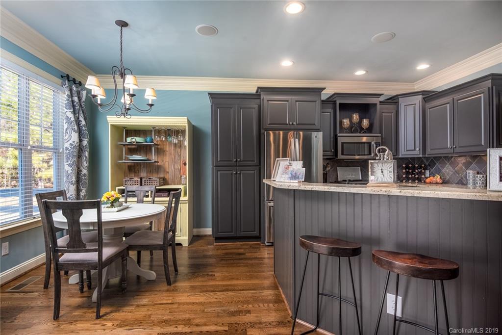2056 Roadrunner Road Clover, SC 29710 - Photo 8 of 25 a kitchen with stainless steel appliances granite countertop a table chairs and a refrigerator