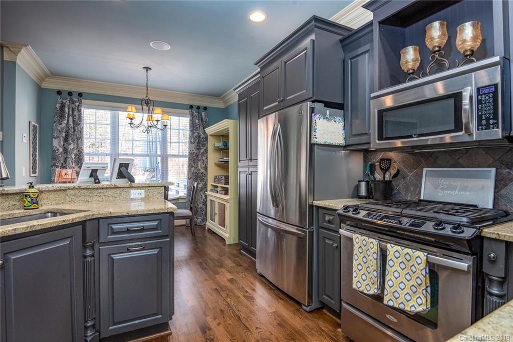 2056 Roadrunner Road Clover, SC 29710 - Photo 9 of 25 a kitchen with stainless steel appliances granite countertop a stove a refrigerator and a microwave