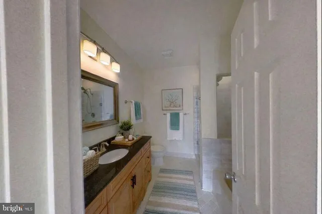 a view of a hallway with workspace and living room