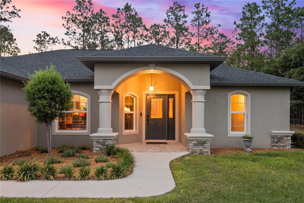 12929 Southwest 89th Street Dunnellon, FL 34432 - Photo 42 of 76 a front view of a house with a porch