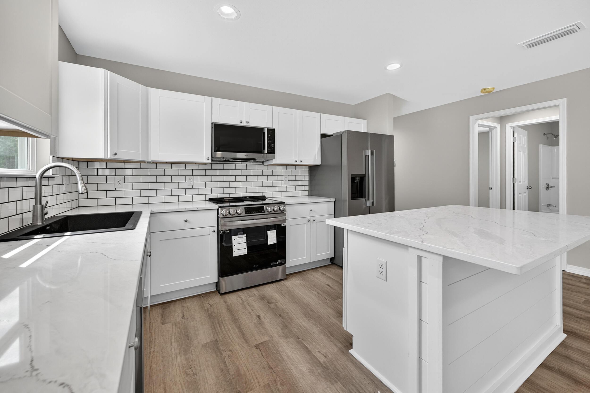 5325 B Kervin Road Crestview, FL 32539 - Photo 15 of 44 a kitchen with stainless steel appliances a stove sink microwave and cabinets