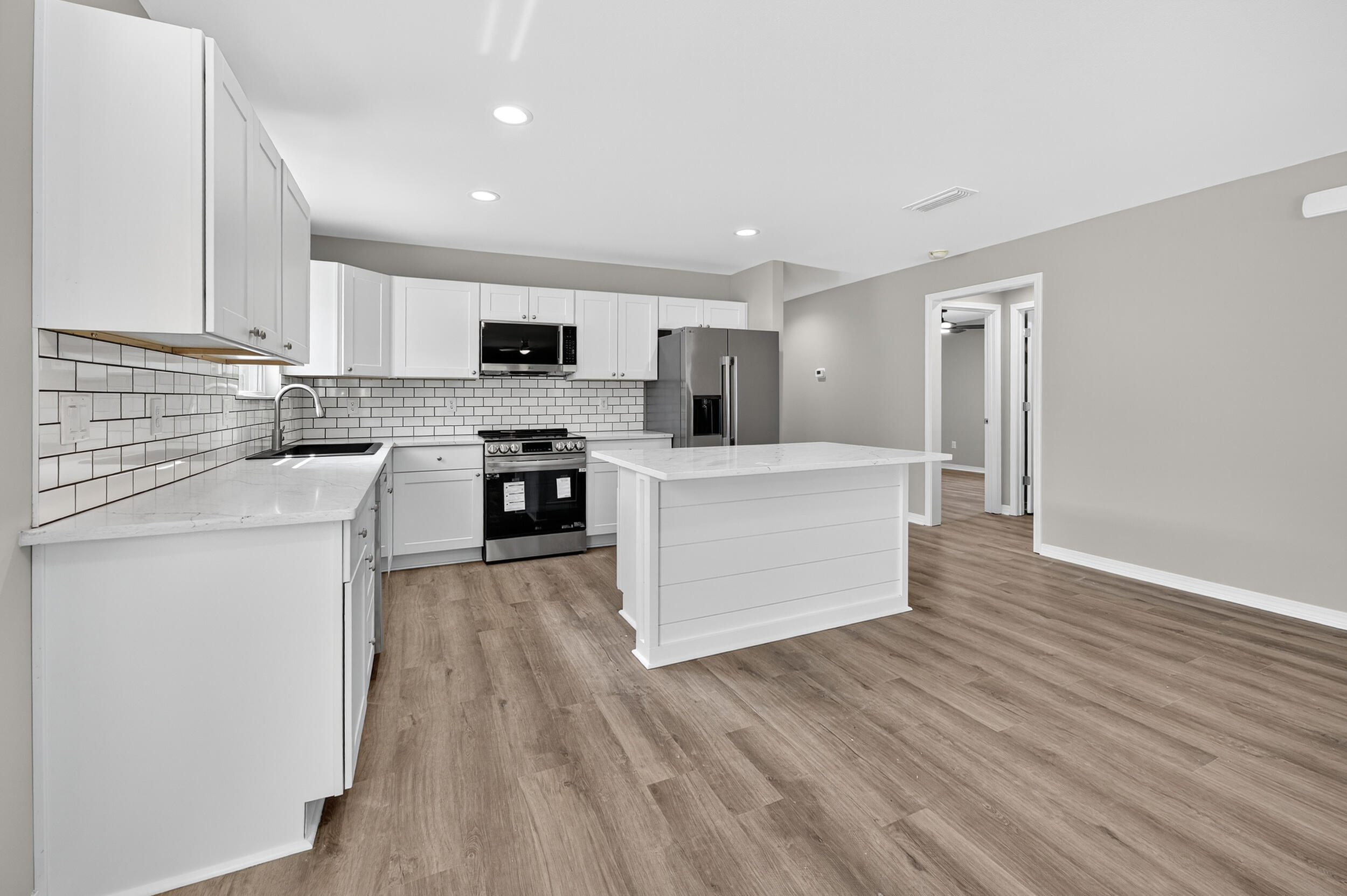 5325 B Kervin Road Crestview, FL 32539 - Photo 16 of 44 a large kitchen with cabinets and stainless steel appliances