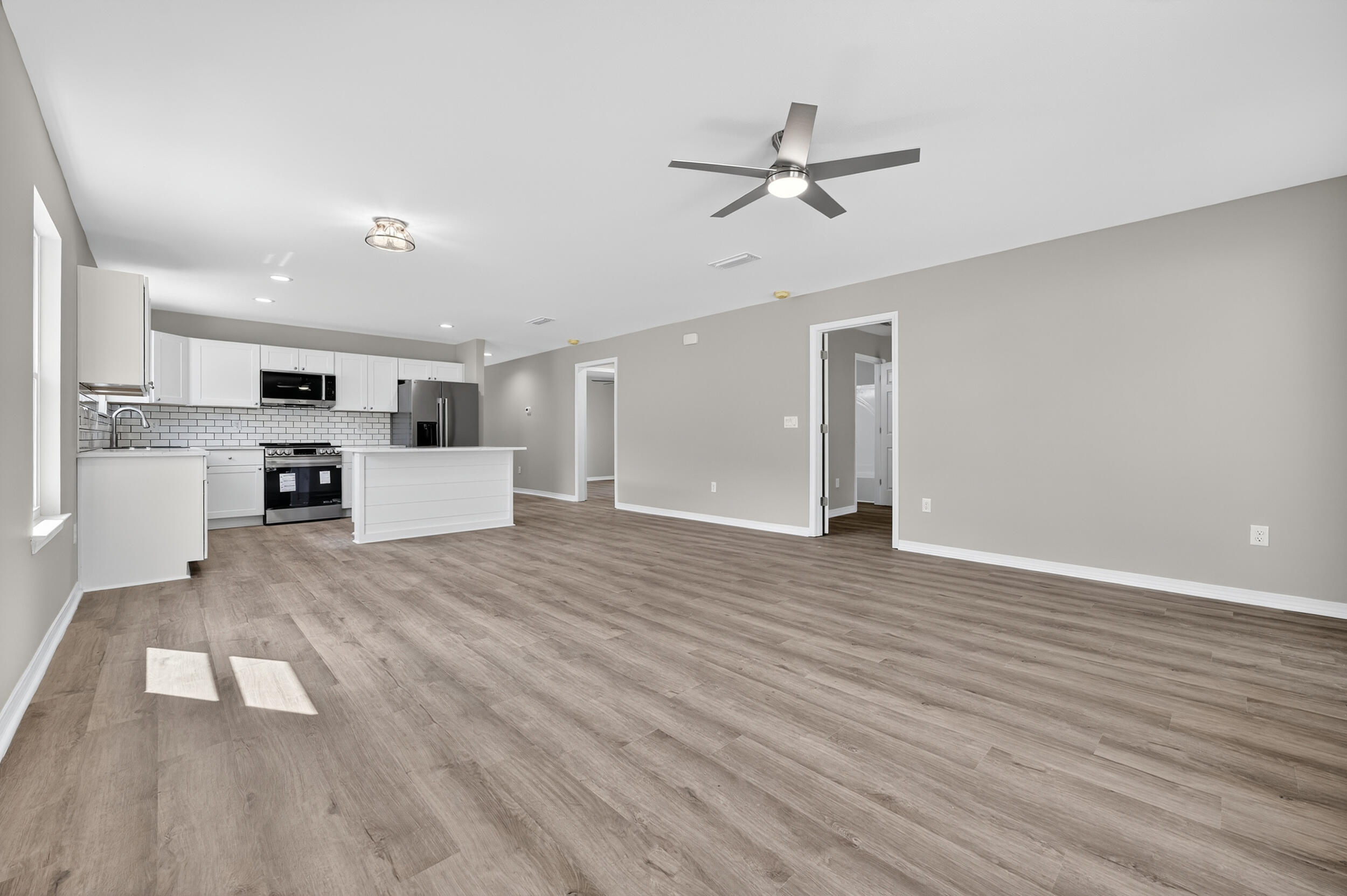 5325 B Kervin Road Crestview, FL 32539 - Photo 19 of 44 a view of a kitchen with a sink and dishwasher a refrigerator with wooden floor