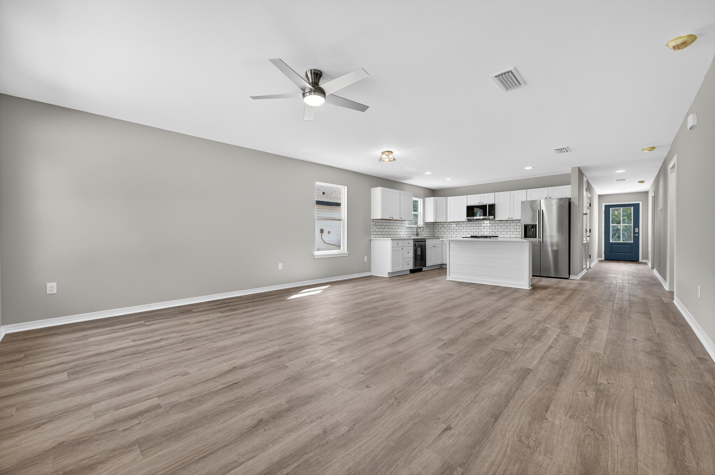 5325 B Kervin Road Crestview, FL 32539 - Photo 20 of 44 a view of empty room with wooden floor and window