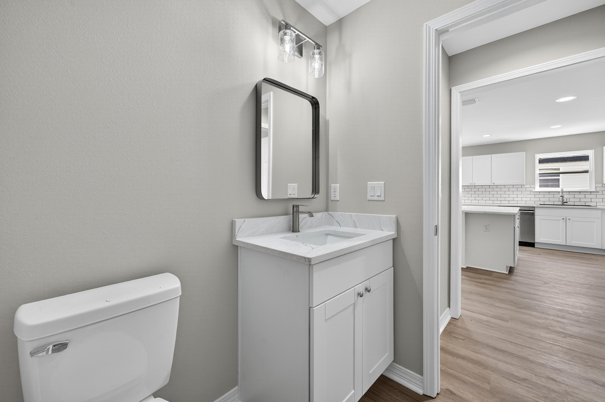 5325 B Kervin Road Crestview, FL 32539 - Photo 31 of 44 a bathroom with a toilet a sink a vanity and mirror
