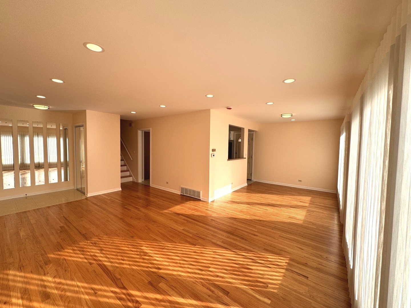 1042 West Central Road Mount Prospect, IL 60056 - Photo 11 of 32 a view of an empty room with wooden floor and a window