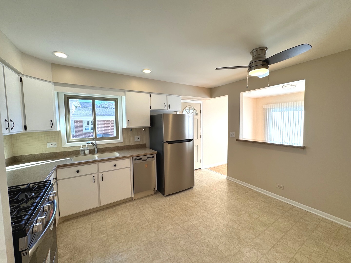 1042 West Central Road Mount Prospect, IL 60056 - Photo 14 of 32 a kitchen with refrigerator and window