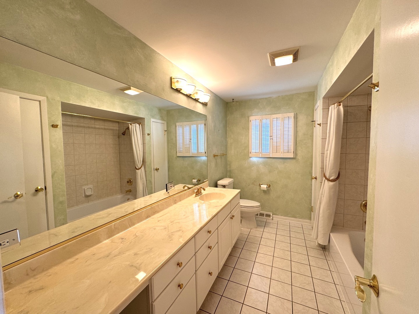 1042 West Central Road Mount Prospect, IL 60056 - Photo 16 of 32 a spacious bathroom with a double vanity sink a mirror and a shower