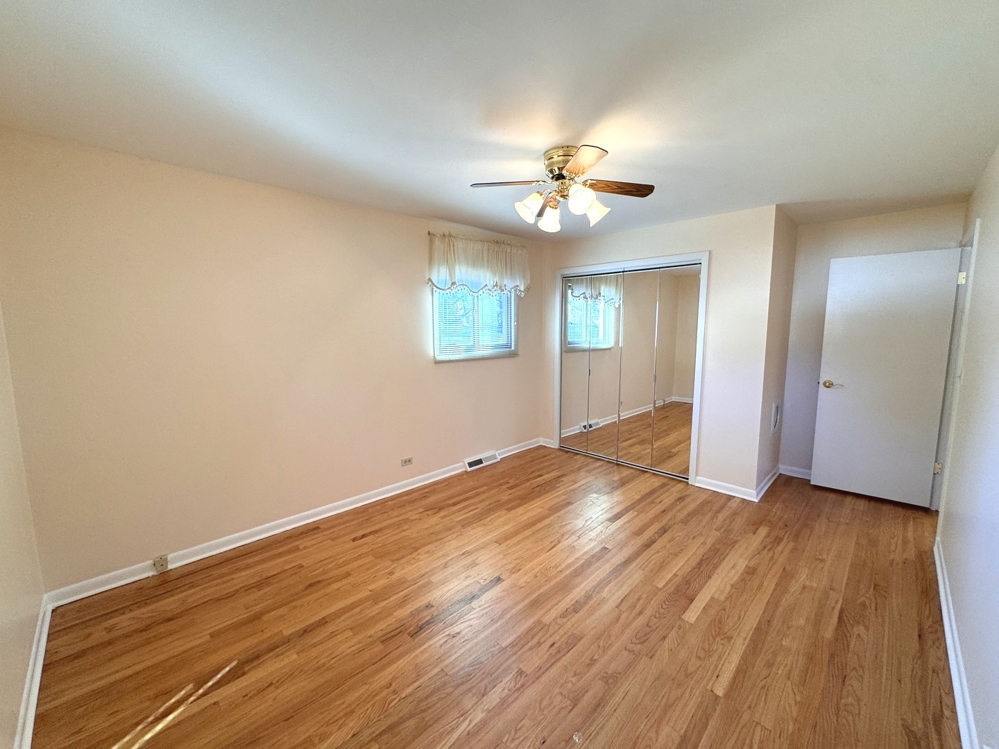 1042 West Central Road Mount Prospect, IL 60056 - Photo 19 of 32 wooden floor in an empty room with a window