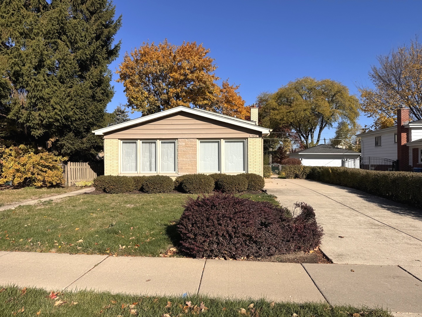1042 West Central Road Mount Prospect, IL 60056 - Photo 2 of 32 a front view of a house with a yard