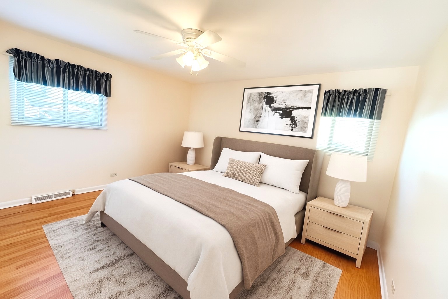 1042 West Central Road Mount Prospect, IL 60056 - Photo 7 of 32 a bedroom with a large bed and a painting on the wall