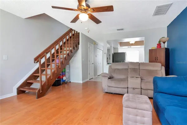 a living room with furniture and stairs