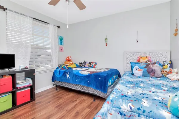 a bedroom with bed and a tv