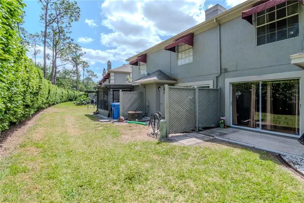 a view of a house with backyard and porch