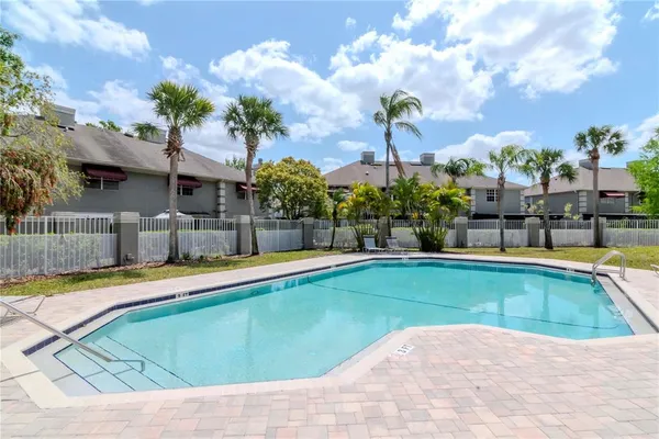 a view of a swimming pool with a lawn chairs