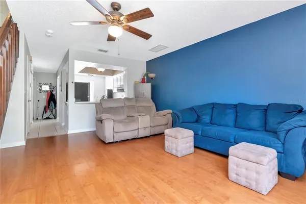 a living room with furniture and a chandelier