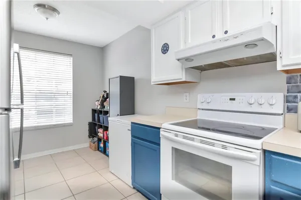a kitchen with a stove and a refrigerator