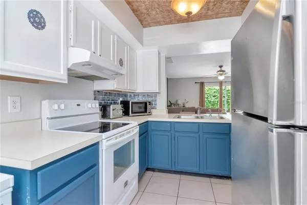 a kitchen with cabinets appliances and a window