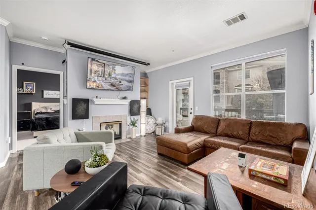 a living room with furniture a fireplace and a flat screen tv