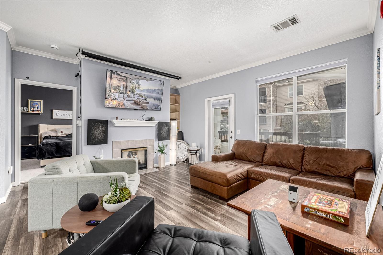 a living room with furniture a fireplace and a flat screen tv