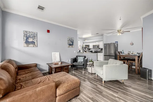 a view of a dining room with furniture a kitchen and chandelier