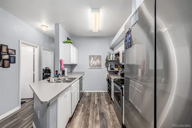 a kitchen with stainless steel appliances a refrigerator stove and sink