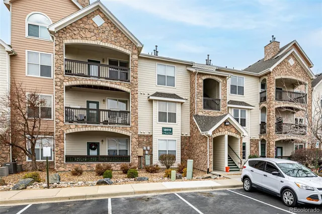 a front view of a residential apartment building with a yard