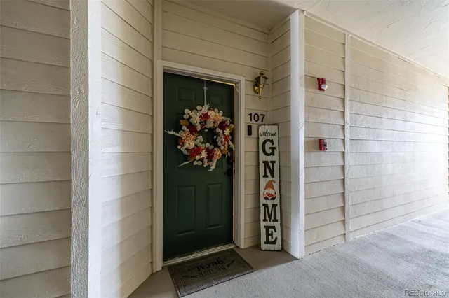 a view of a hallway with wooden floor and closet