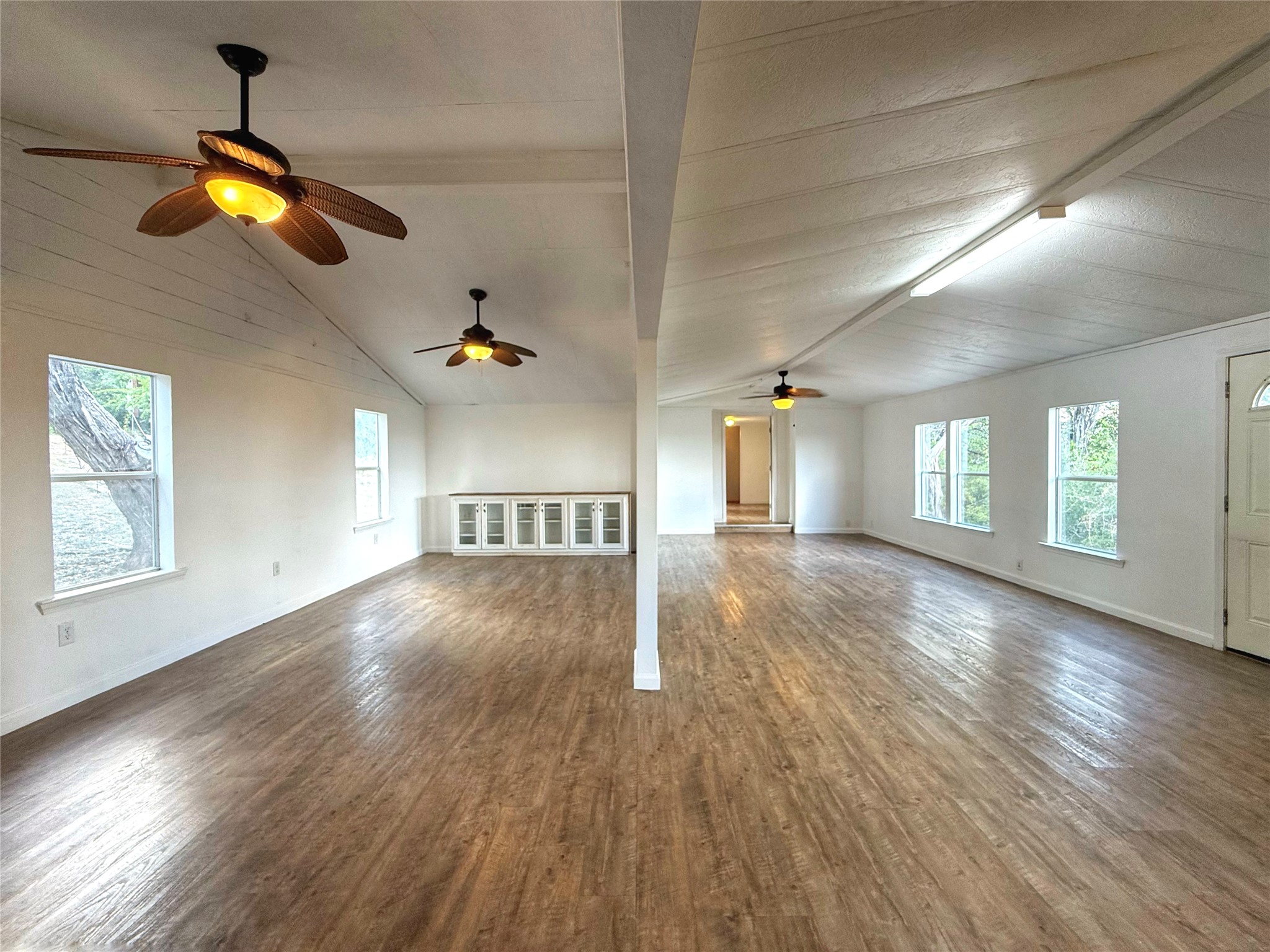 10601 Ridge Rim Drive Leander, TX 78641 - Photo 28 of 35 Vaulted wood-paneled ceilings and warm-toned flooring define this spacious, open-concept living area.