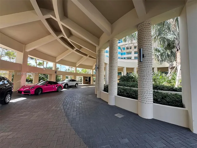 a view of parking garage with cars parked