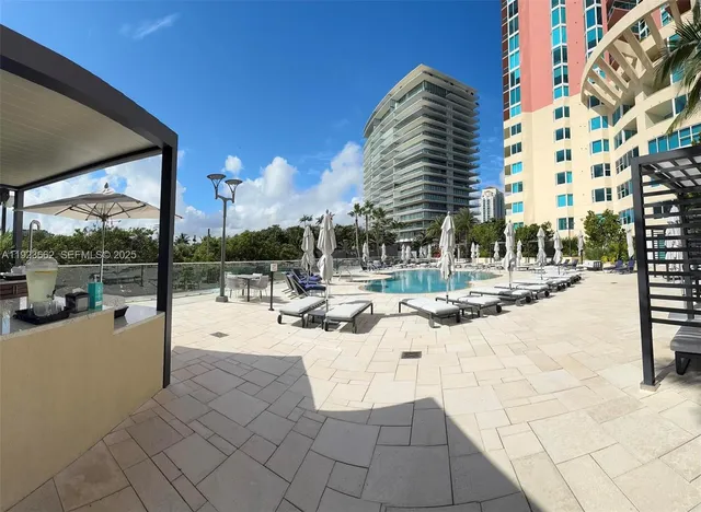 a view of a patio with a table and chairs under an umbrella