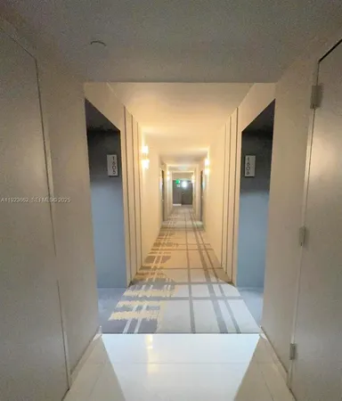 a view of a hallway with wooden shelves