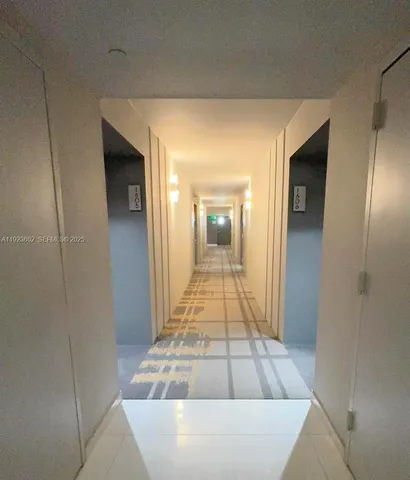 a view of a hallway with wooden shelves