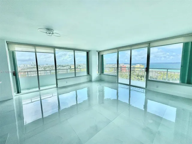 a view of an empty room with glass door