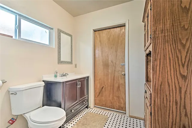 a bathroom with a toilet a sink and shower