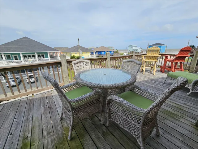 a view of a chairs and table on the wooden deck