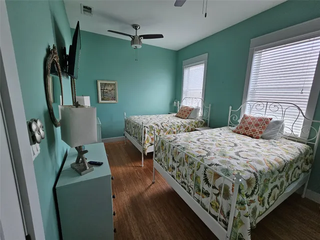 a bedroom with a bed window and a chair