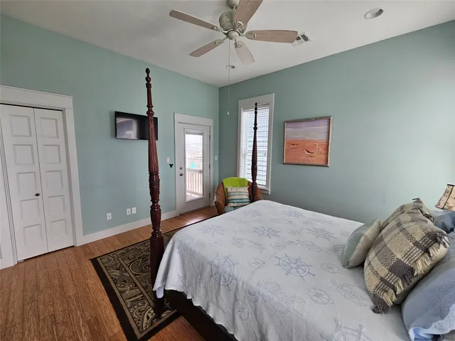 a bedroom with a large bed and a chandelier
