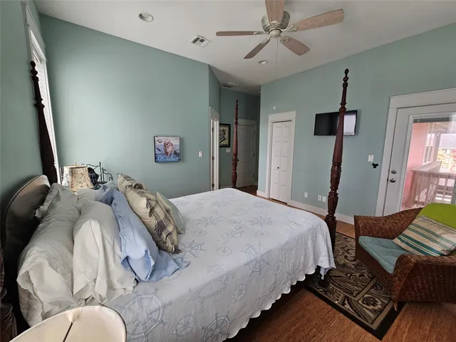 a bedroom with bed and wooden floor