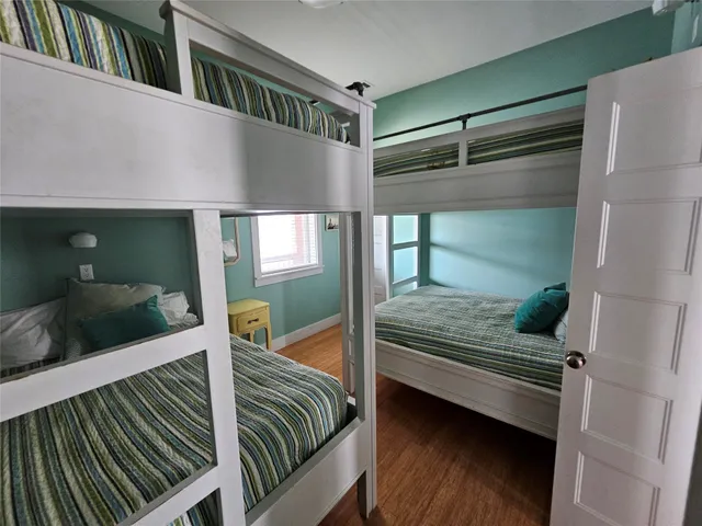 a bedroom with double bunk beds and a window