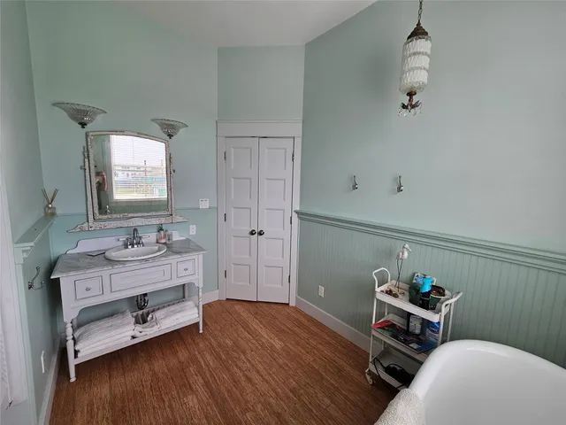 a room with a table chairs and wooden floor
