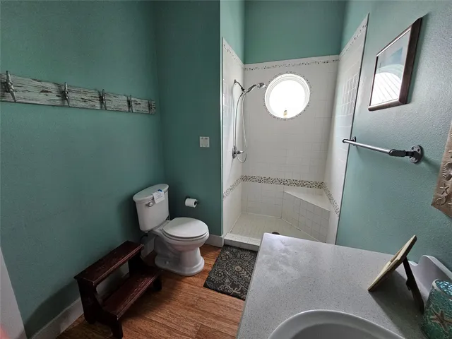 a bathroom with a toilet and a mirror