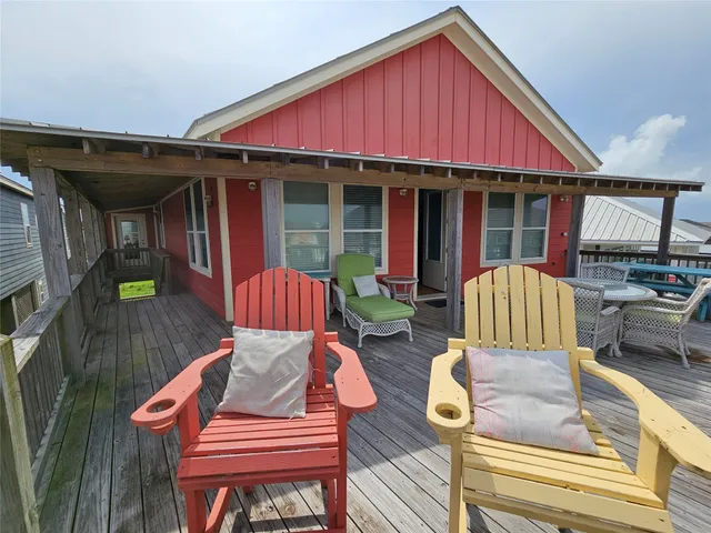 a view of patio with a table and chairs under an umbrella