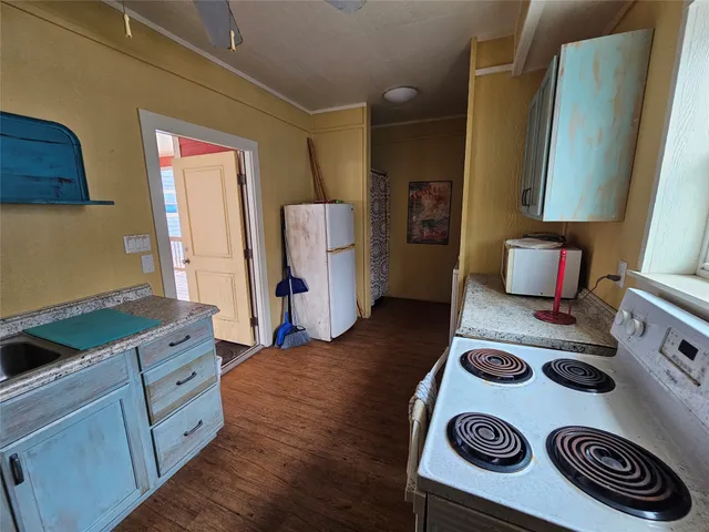 a kitchen with a refrigerator and a stove