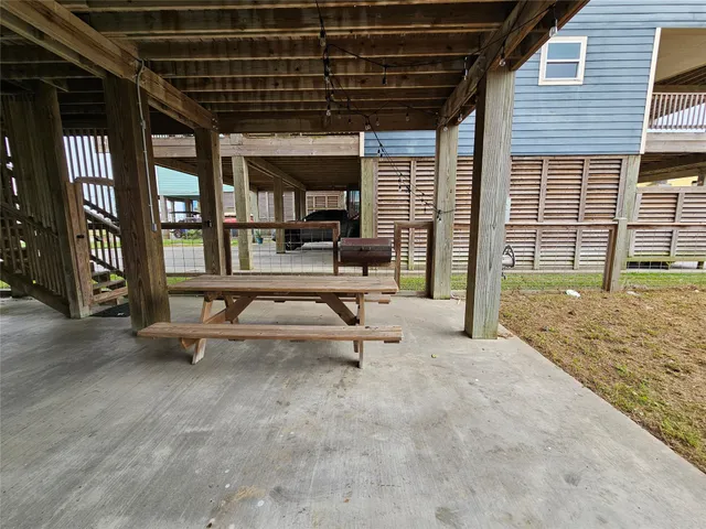 a view of a hall with wooden floor and a fireplace