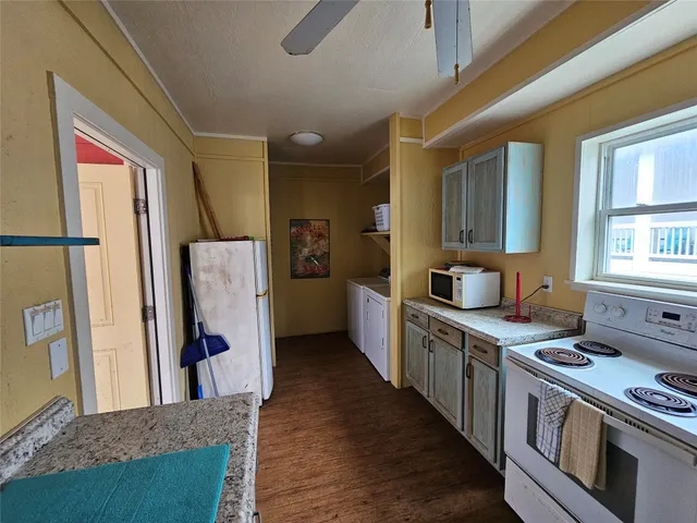 a kitchen with stainless steel appliances granite countertop a refrigerator a stove and a sink