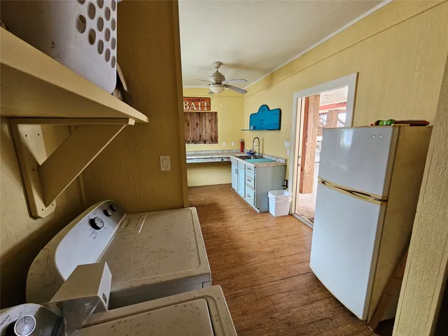a kitchen with a refrigerator and a stove