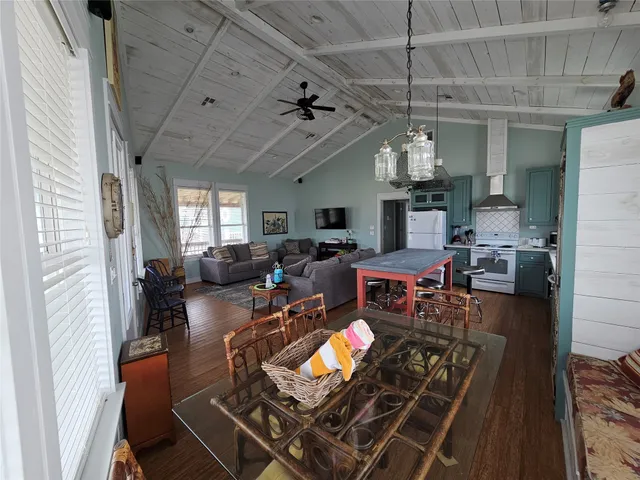 a living room with lots of furniture and a chandelier