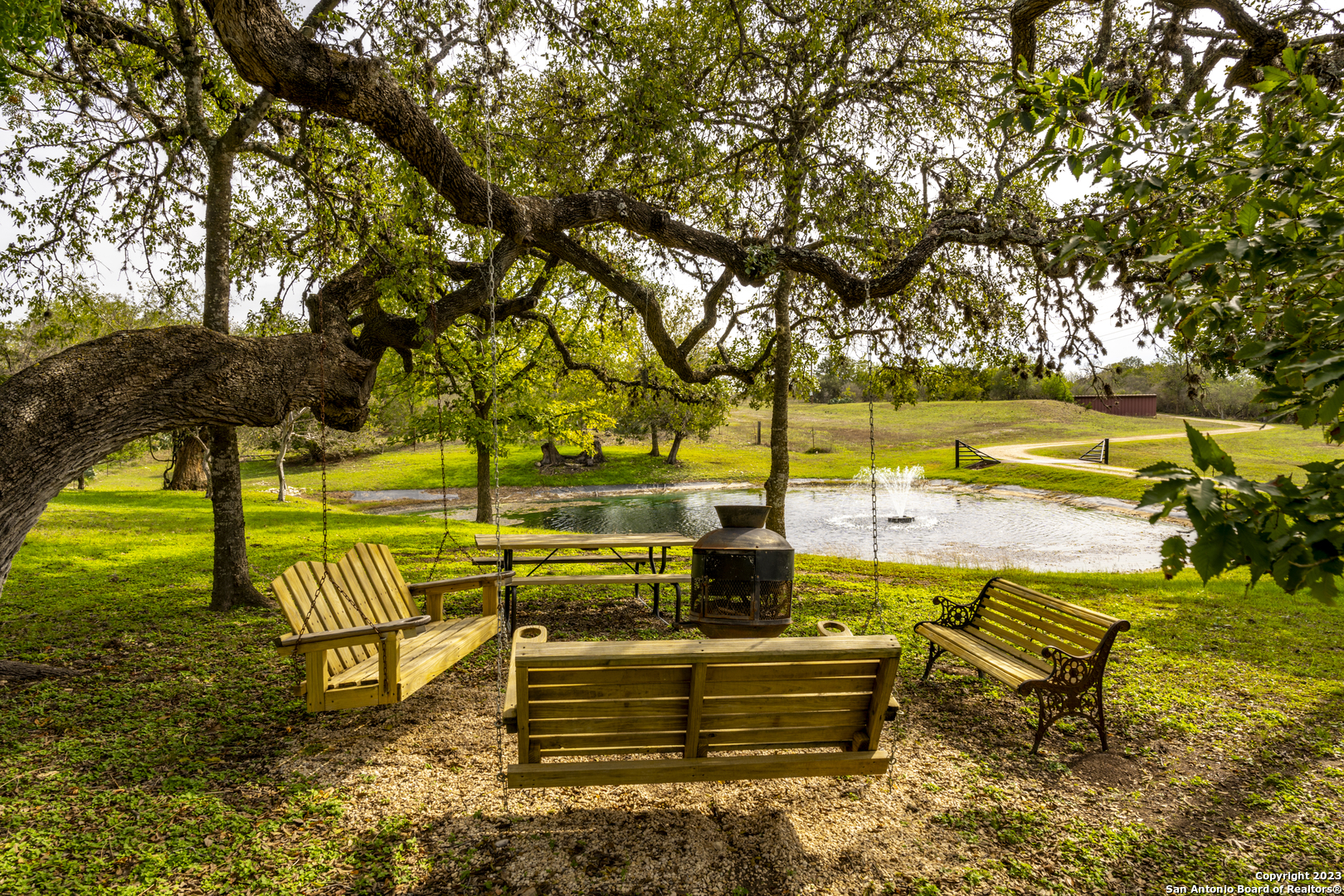 a view of swimming pool with outdoor seating and trees